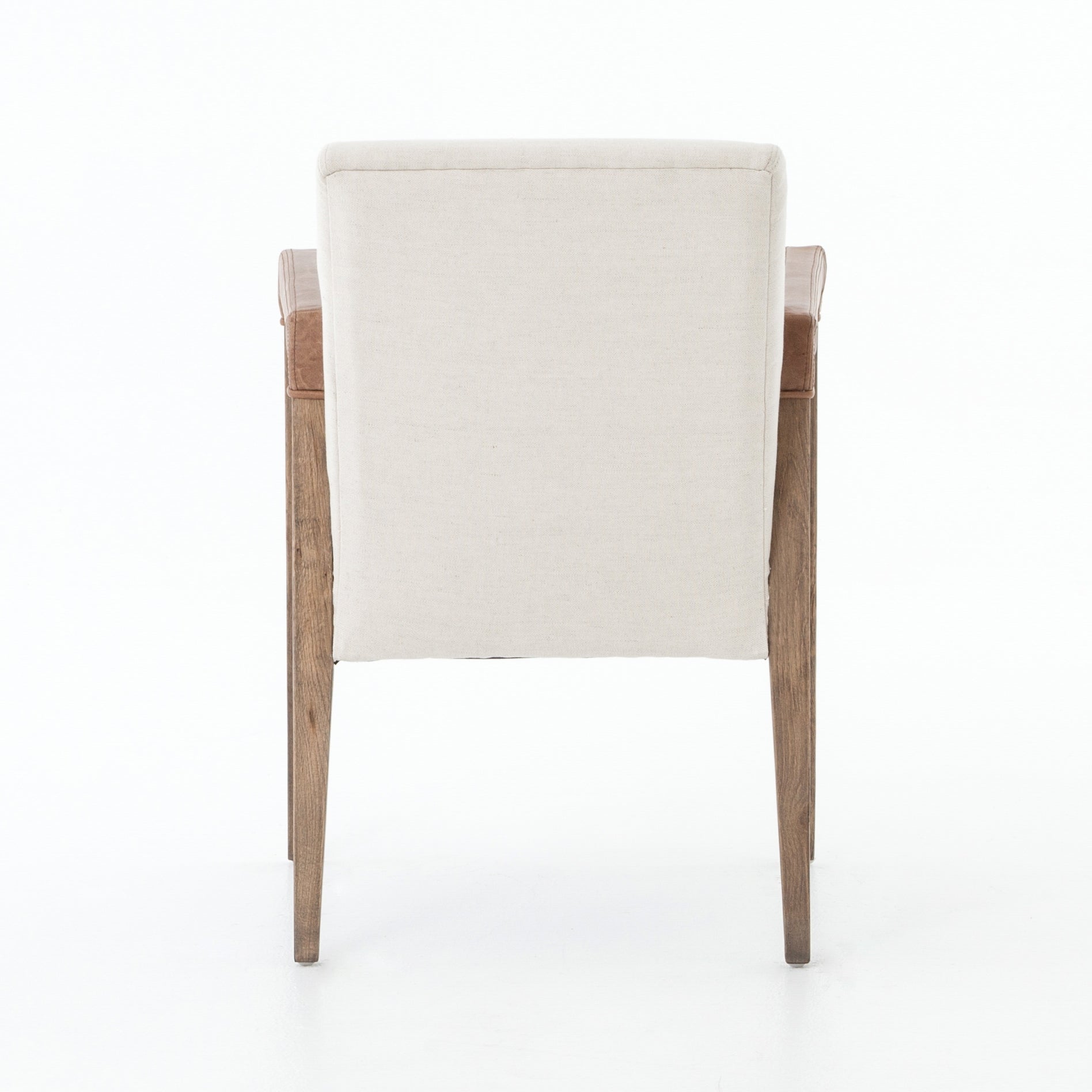Elegance is no exaggeration with this Reuben Dining Chair - Harbor Natural. Slim, tapered oak with arms wrapped in vintage leather frames a floating seat covered in natural linen. We'd love to see this in your dining room, kitchen, or other space!  Overall Dimensions: 23.25"w x 25.50"d x 33.75"h