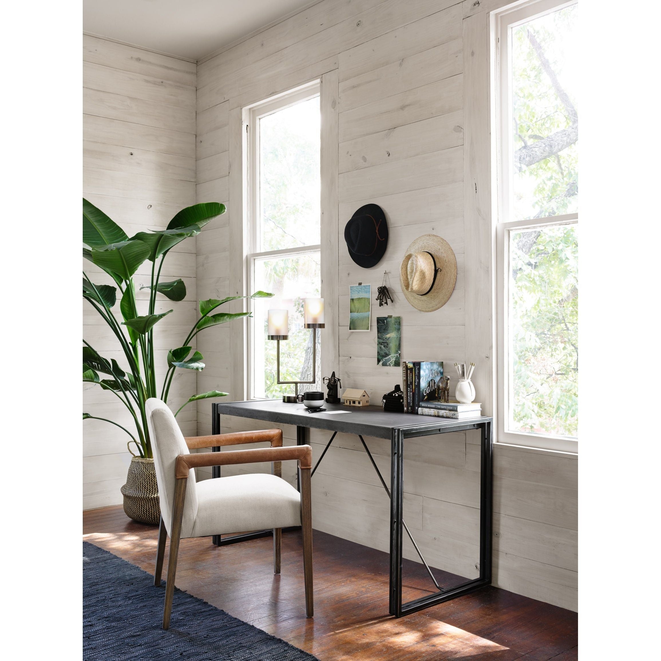 Elegance is no exaggeration with this Reuben Dining Chair - Harbor Natural. Slim, tapered oak with arms wrapped in vintage leather frames a floating seat covered in natural linen. We'd love to see this in your dining room, kitchen, or other space!  Overall Dimensions: 23.25"w x 25.50"d x 33.75"h