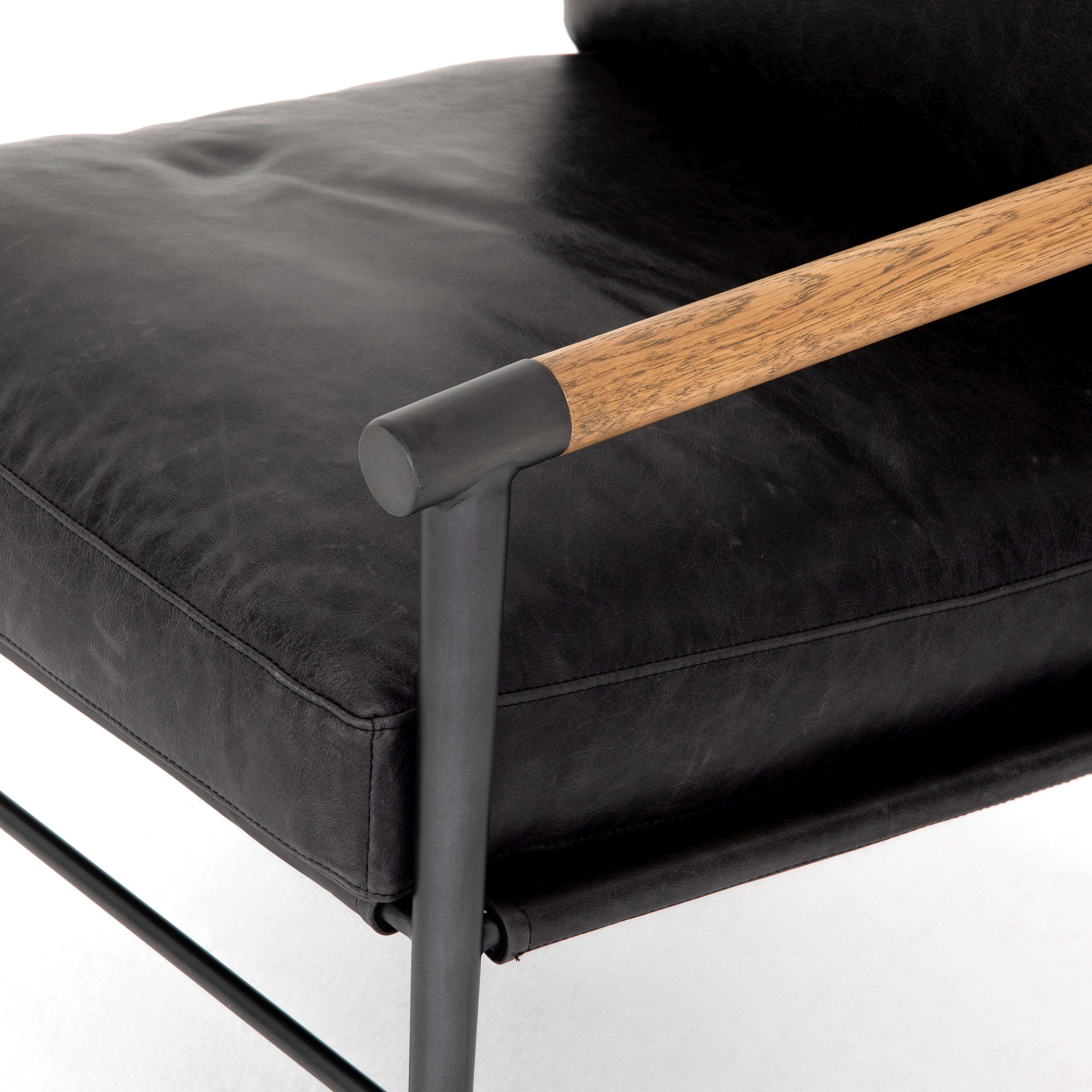 Featuring Rowen Chair - Sonoma Black by Four Hands at Amethyst Home. This Rowen Chair - Sonoma Black has buttery black seating of top-grain leather, with angular arms of exposed oak providing fresh contrast. A comfy, modern chair to add to any living room, bedroom, or other area. 
Overall Dimensions: 27.50"W x 32"L x 31"HColors: Toasted Oak, Sonoma Bla.  Amethyst Home provides interior design, new home construction design consulting, vintage area rugs, and lighting in the Winter Garden metro area.