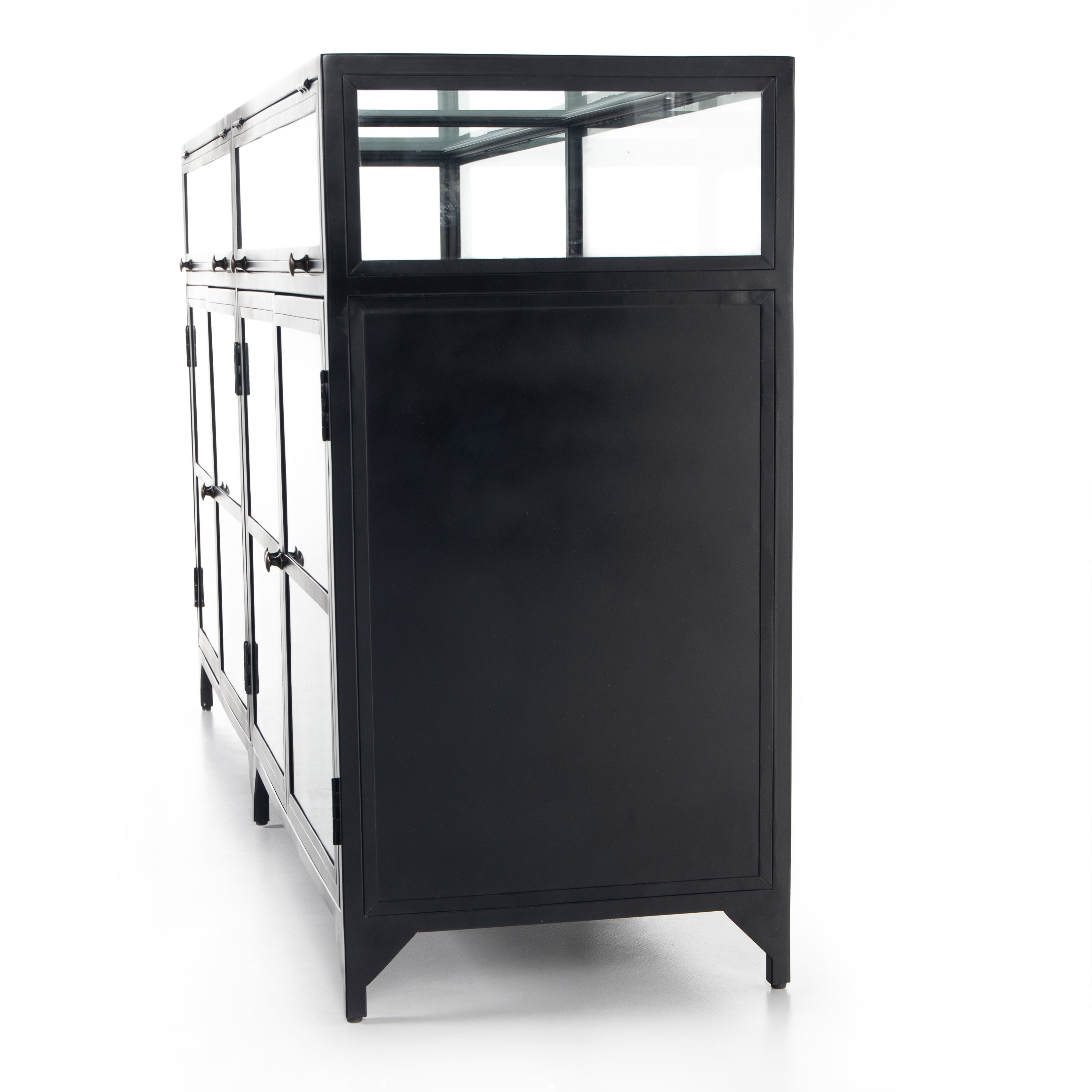 This Shadow Box Sideboard gives your inner collector a place to play. Store prized possessions behind clear glass fronts, with black-finished metal casing and brass hardware for contrast.  Overall Dimensions: 70.00"w x 17.25"d x 35.00"h