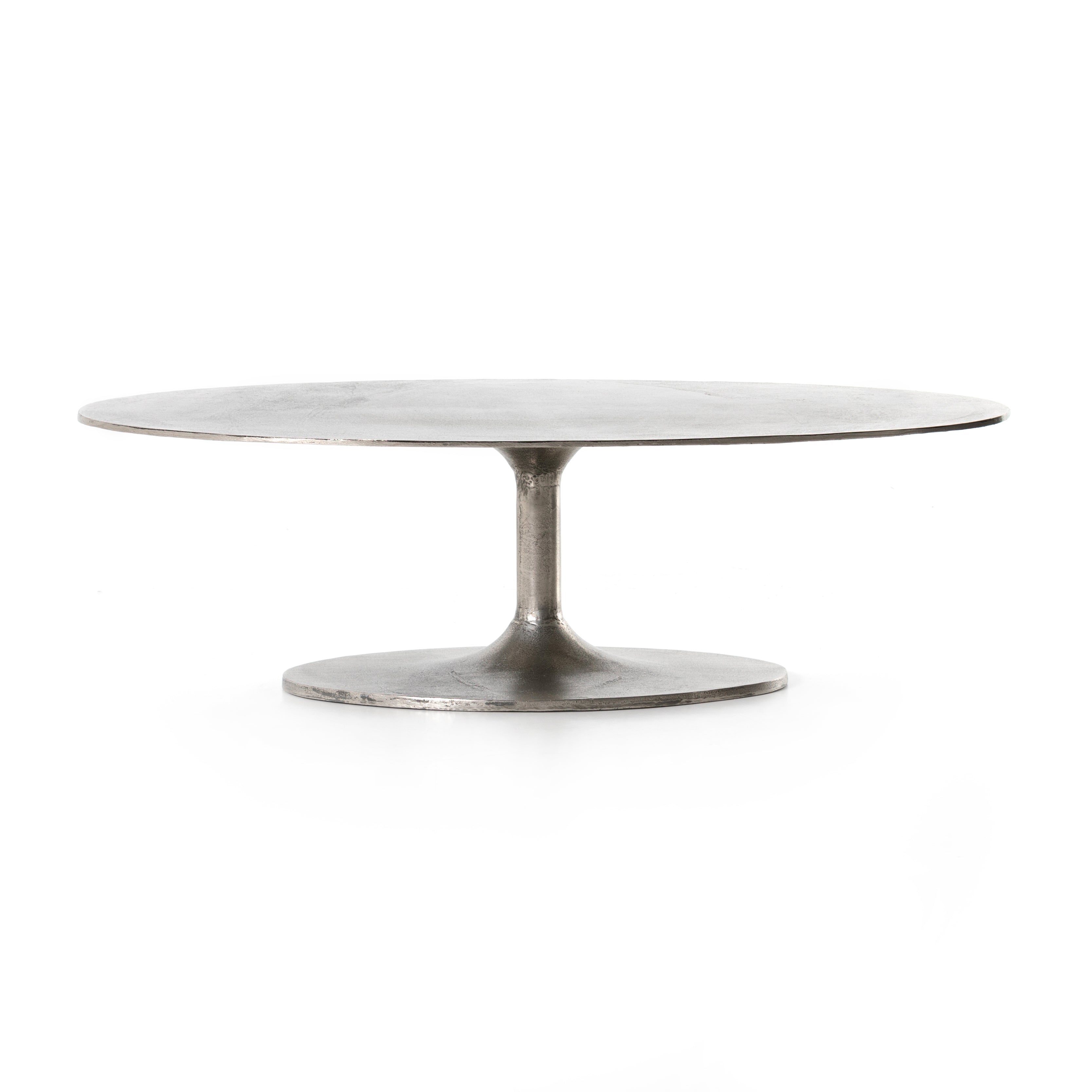 We love the oval shape of this Simone Coffee Table - Antique Nickel. The textural cast aluminum makes for a beautifully modern coffee table, with alluring highs and lows played up by a raw nickel finish. Great indoors or out; cover or store indoors during inclement weather and when not in use.  Overall Dimensions: 54.75"w x 29.25"d x 16.50"h