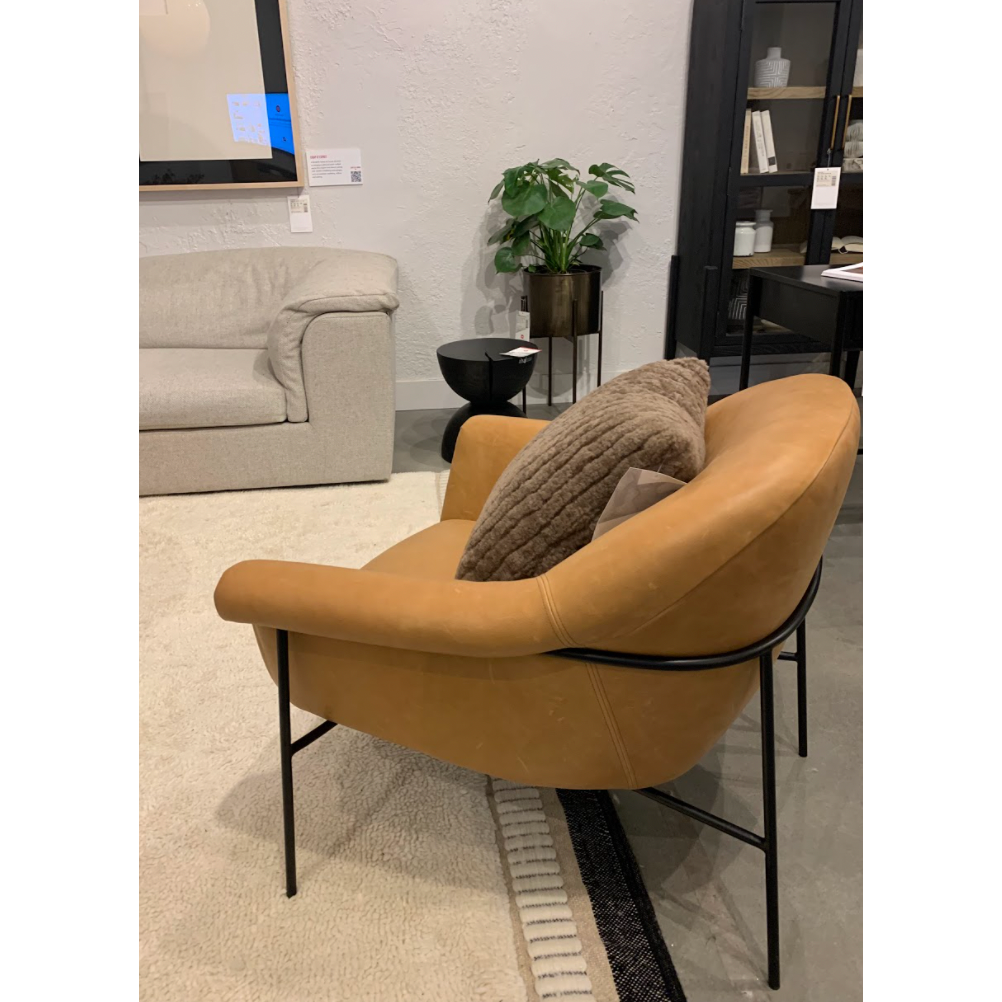 With a curvy silhouette and classic rolled arms, this Suerte Chair - Palermo Butterscotch has butterscotch leather that lends a fresh feel to vintage-inspired accent seating. The airy iron cradle base brings a beautiful balance of scale to any living room or office! Amethyst Home provides interior design, new home construction design consulting, vintage area rugs, and lighting in the Charlotte metro area.