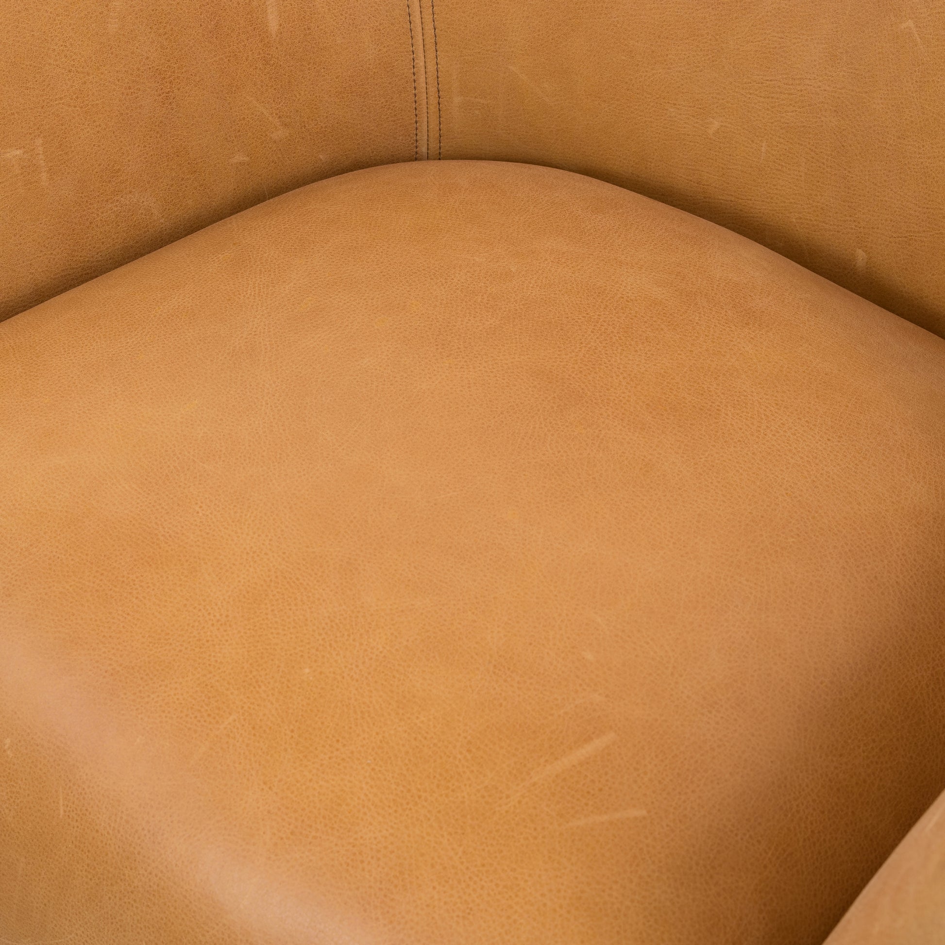 With a curvy silhouette and classic rolled arms, this Suerte Chair - Palermo Butterscotch has butterscotch leather that lends a fresh feel to vintage-inspired accent seating. The airy iron cradle base brings a beautiful balance of scale to any living room or office!  Overall Dimensions: 35.00"w x 33.50"d x 31.00"h