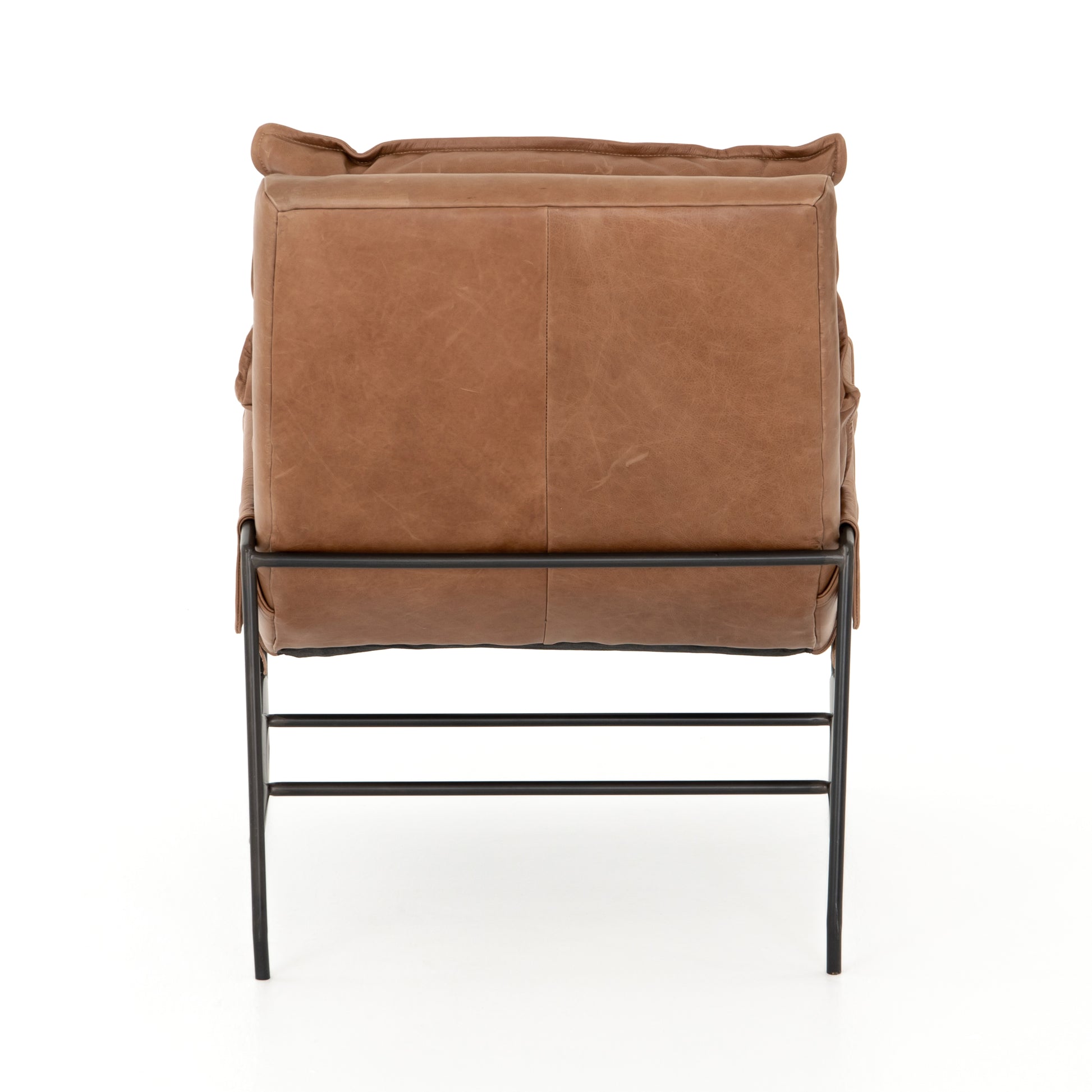 A nod to relaxed modernism, playing up the natural depth of exclusive top-grain leather, with buckle details and low-slung styling crafting the hippest of vibes.  Overall Dimensions: 28.00"w x 37.00"d x 35.00"h Seat Depth: 22" Seat Height: 20" Arm Height from Floor: 23.5" Arm Height from Seat: 3.5"  Colors: Waxed Ebony, Chaps Saddle Materials: Iron, Top Grain Leather