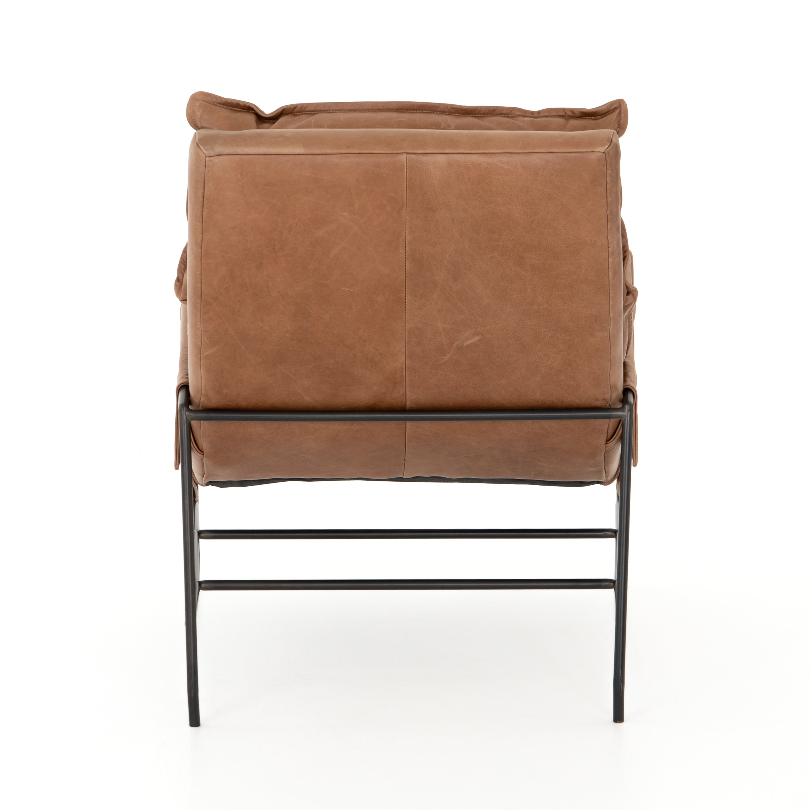 A nod to relaxed modernism, playing up the natural depth of exclusive top-grain leather, with buckle details and low-slung styling crafting the hippest of vibes.  Overall Dimensions: 28.00"w x 37.00"d x 35.00"h Seat Depth: 22" Seat Height: 20" Arm Height from Floor: 23.5" Arm Height from Seat: 3.5"  Colors: Waxed Ebony, Chaps Saddle Materials: Iron, Top Grain Leather