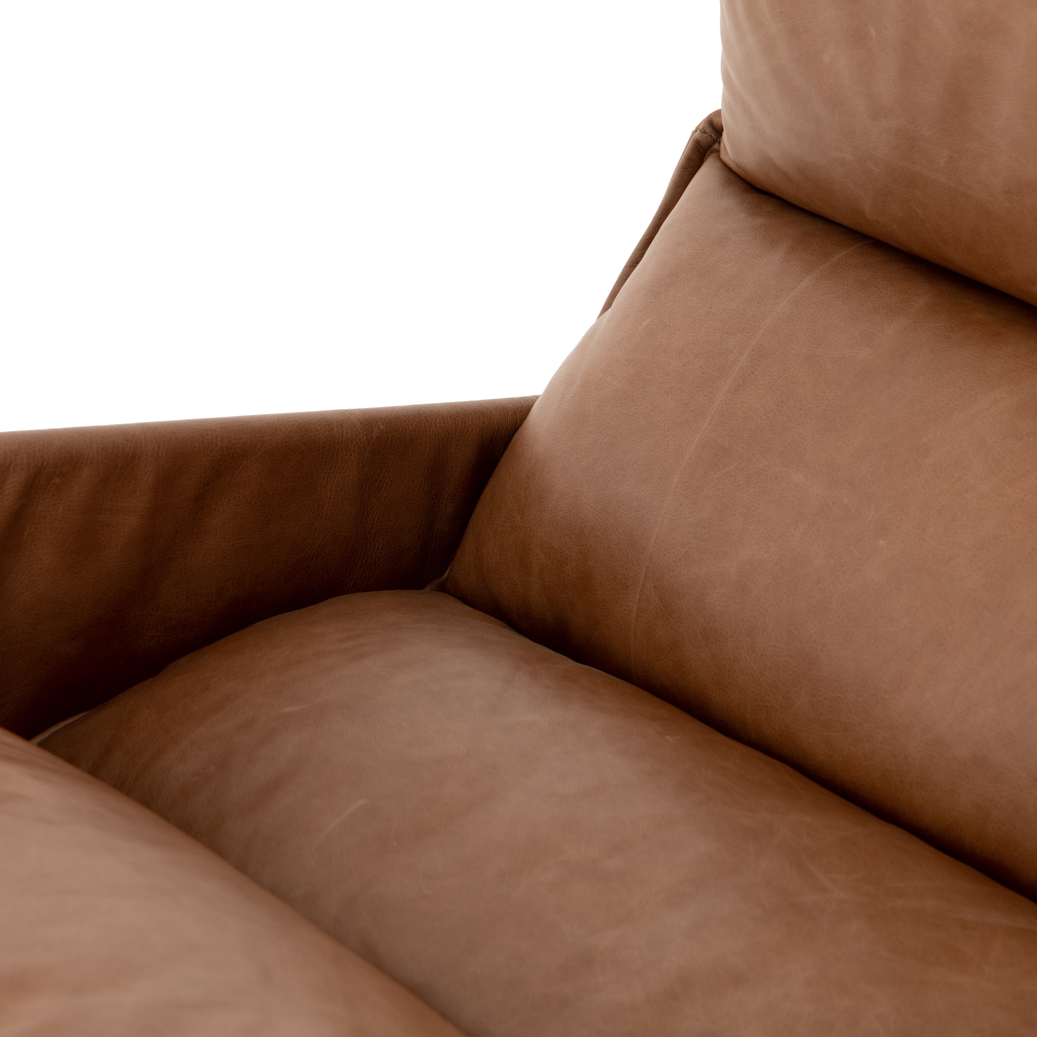 A nod to relaxed modernism, playing up the natural depth of exclusive top-grain leather, with buckle details and low-slung styling crafting the hippest of vibes.  Overall Dimensions: 28.00"w x 37.00"d x 35.00"h Seat Depth: 22" Seat Height: 20" Arm Height from Floor: 23.5" Arm Height from Seat: 3.5"  Colors: Waxed Ebony, Chaps Saddle Materials: Iron, Top Grain Leather