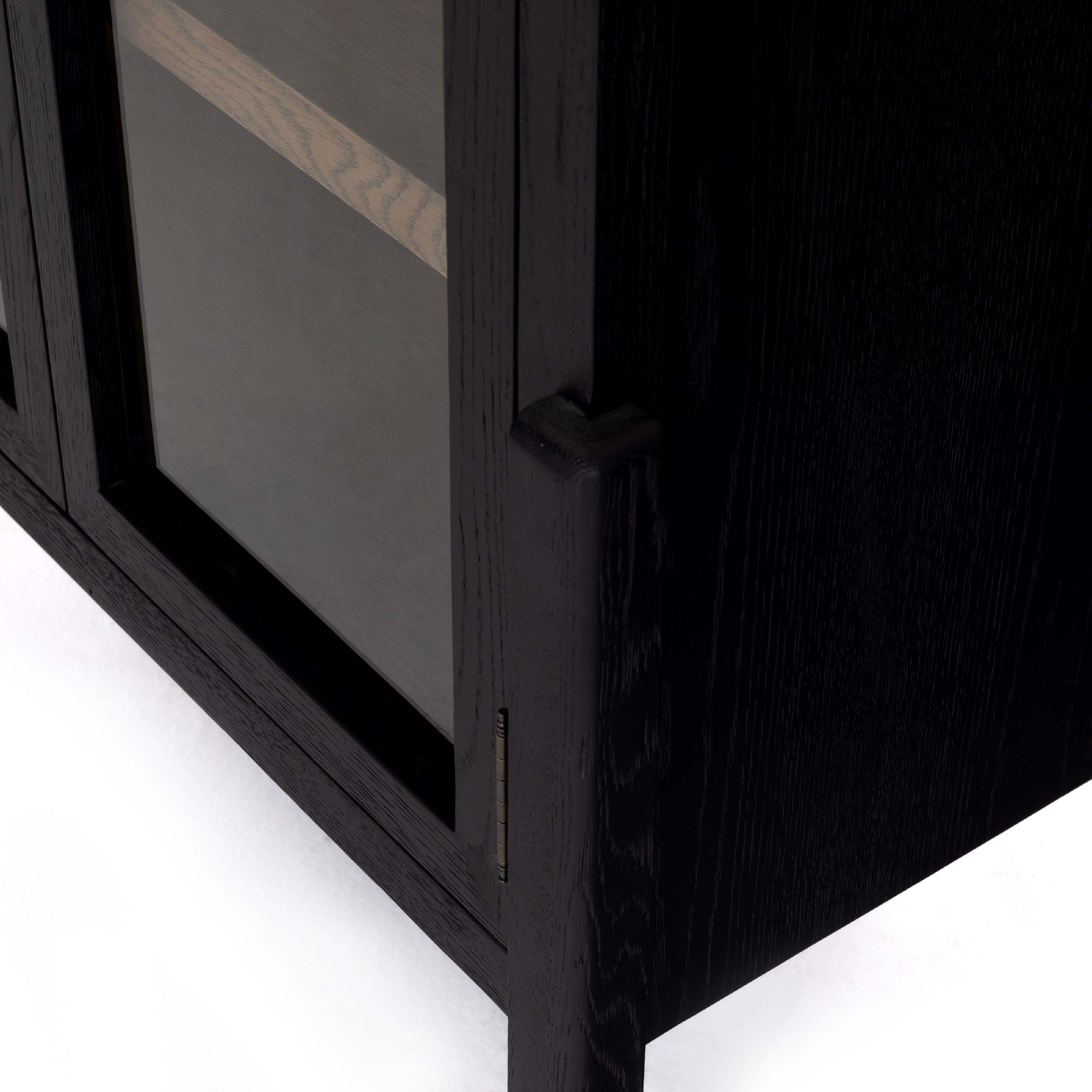 Store it in style with this Tolle Cabinet - Drifted Oak. Beautifully shaped cabinetry of black solid oak features spacious interior shelving and clear glass front, ready for displaying favorite books, photos and treasures in any room!  Overall Dimensions: 38.00"w x 19.00"d x 84.00"h