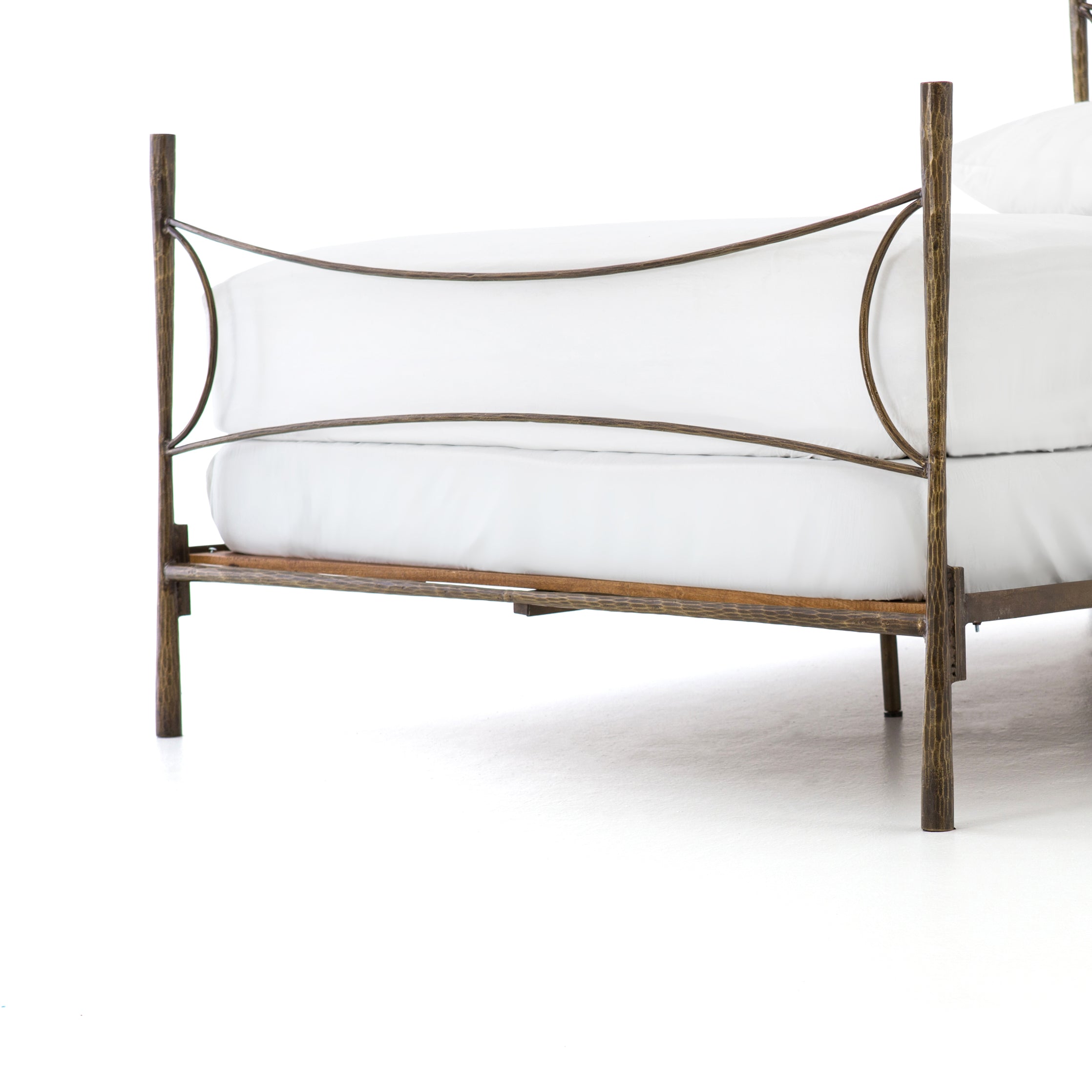 Beguiling curves soften hard materials for marked drama with this Westwood Bed. Slim, hammered iron is finished in antique brass for depth that defies this frame's feminine air. Low-profile box spring recommended.