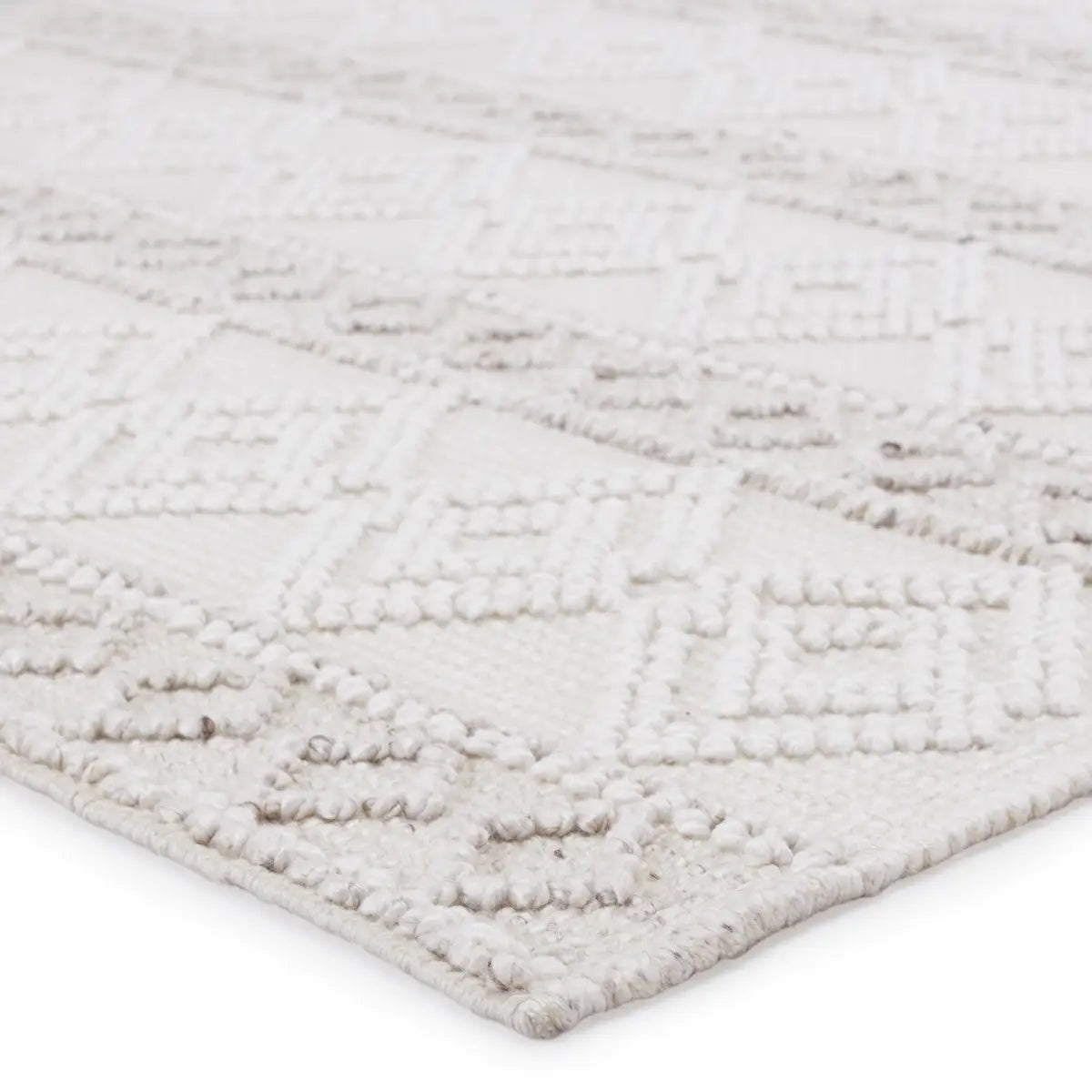 The handwoven Cosette Adelie Area Rug by Jaipur Living showcases a boucle-style geometric design in a light and airy colorway of white and soft gray. Crafted of PET yarn, or recycled plastic, this chic and durable rug brings warmth and a hint of global appeal to indoor and outdoor spaces alike.