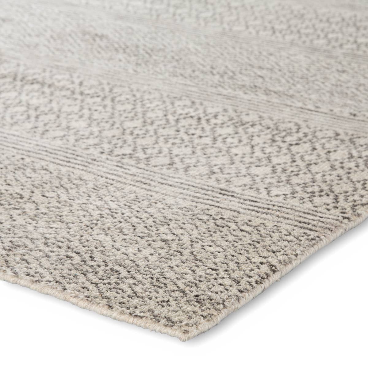 The Rize Neema Area Rugs offers intricate and delicately designed global patterns to the modern home. Small-scale geometric motifs create a captivating banded design on the artistically distressed Neema area rug. In a light neutral colorway of white and gray, this durable hand-knotted wool accent blends a timeless craft with contemporary charm.  Hand Knotted 100% Wool RIZ02