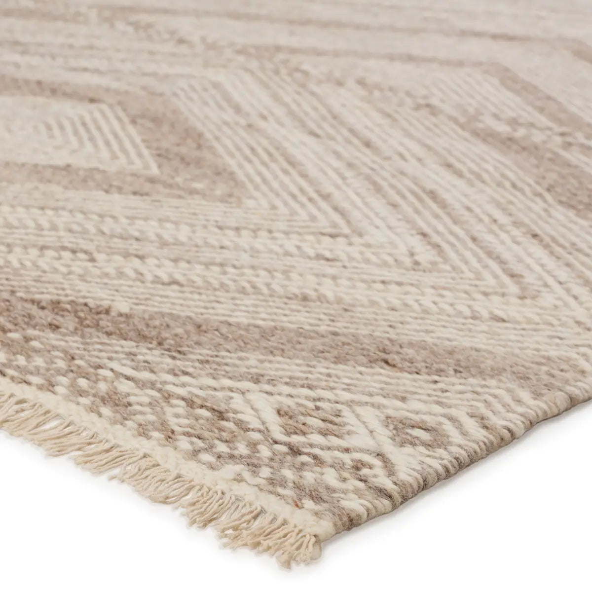 The handwoven Satori Suriya Area Rug by Jaipur Living features a versatile, neutral palette and an intricate tribal and diamond pattern. The short fringe detail adds texture to this light brown and cream-colored piece. This Moroccan style area rug fits perfectly in high traffic areas. 