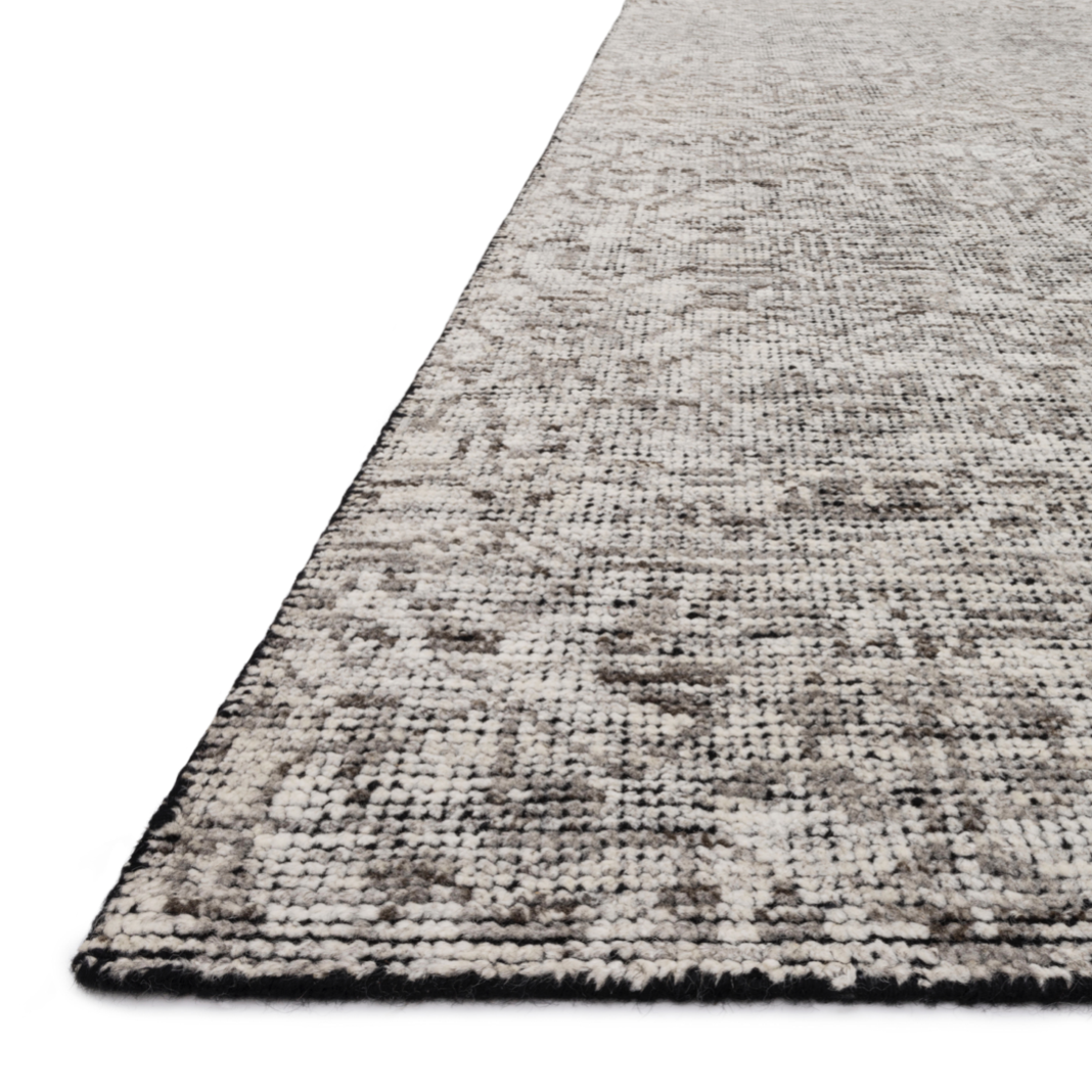 Hand-knotted in India of 100% wool, the Amara Ivory/Taupe Area Rug creates a casual yet refined vibe with high-end appeal. With shades of ivory, taupe, and black, this is a gorgeous rug to showcase in your living room, entryway, bedroom, or other high traffic area.   Hand Knotted 100% Wool AMM-04 Ivory/Taupe