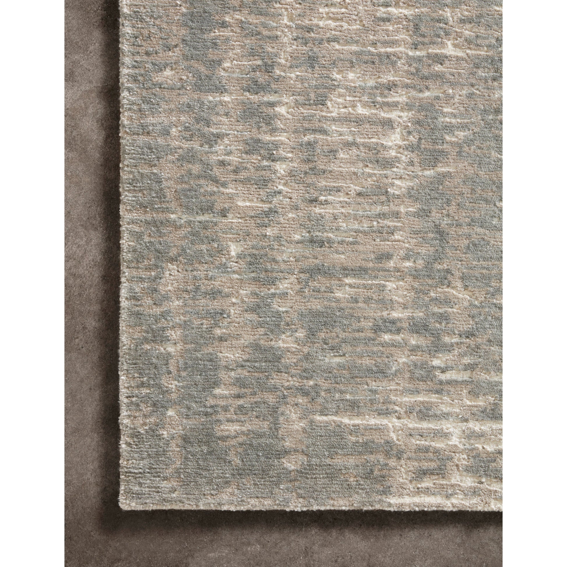 The Atlas Ivory / Pewter Area Rug by Loloi, or ATL-01, showcases striking contemporary patterns with a sophisticated color palette. Bold yet approachable, Atlas' muted linear designs create a sense of refined movement. Hand Knotted. Wool | Nylon