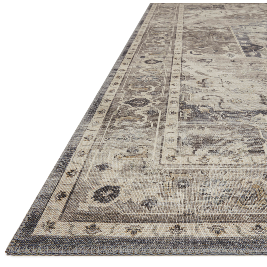 Featuring soft motifs in a carefully curated color palate of grey, black, ivory and hints of blue, the Hathaway Steel / Ivory area rug captures the essence of one-of-a-kind vintage or antique area rug at an attractive price.