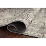 Featuring soft motifs in a carefully curated color palate of grey, black, ivory and hints of blue, the Hathaway Steel / Ivory area rug captures the essence of one-of-a-kind vintage or antique area rug at an attractive price.