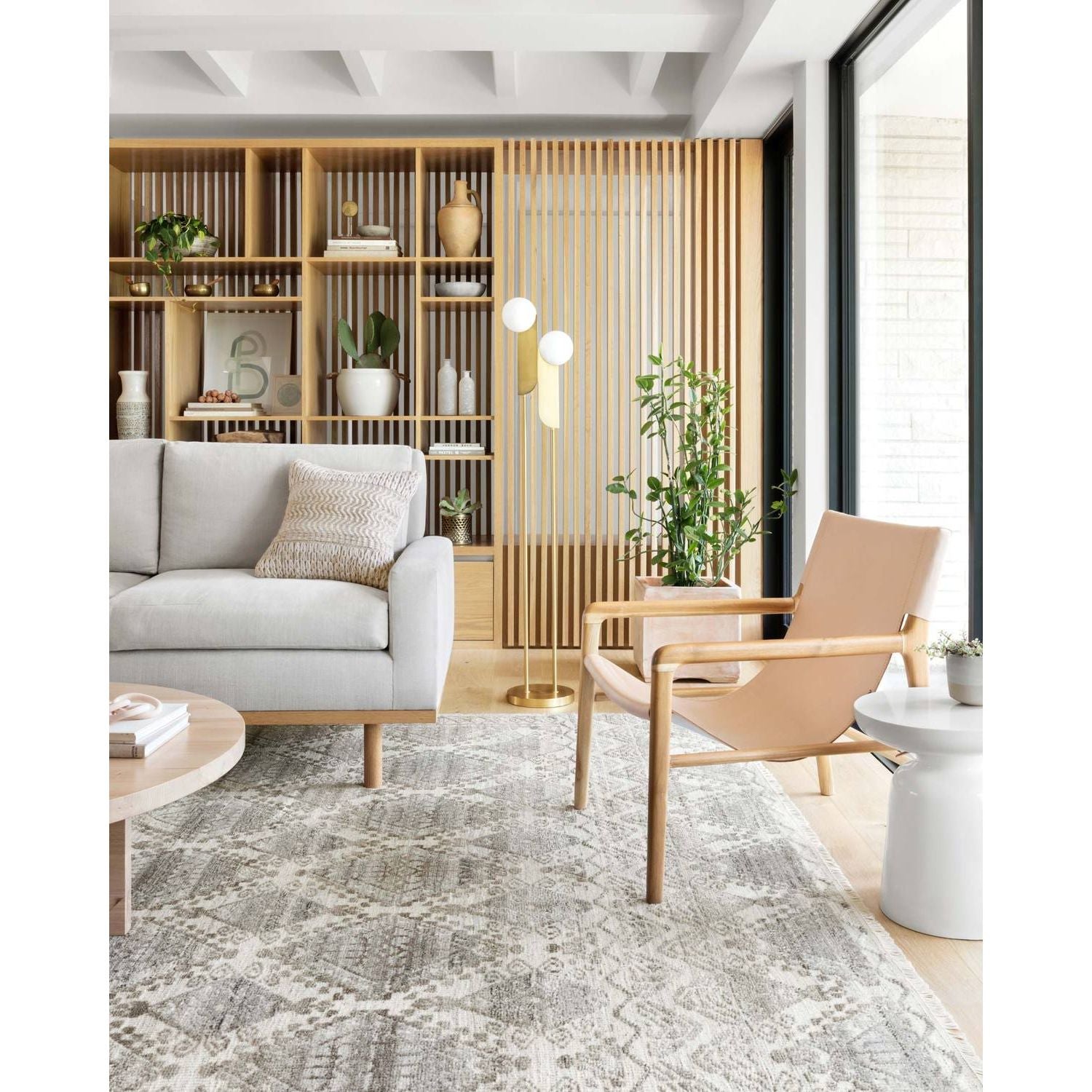 The Idris Stone area rug from Loloi is meticulously hand-knotted of viscose and wool. You will love this rug because the rug is:  Perfect for entryways, living rooms, and bedrooms Easy to clean and maintain Gorgeous with the intricate pattern and patina Warms up any room with the high / low pile Hand-Knotted 70% Viscose | 30% Wool ID-01 Stone