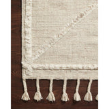 A new take on Moroccan style rugs, the Iman Beige/Ivory Rug from Loloi is hand-knotted of 100% wool pile by skilled artisans. The surface features linear and braided details, creating tonal variations that make each piece unique. Plus, each design is finished with a playful fringe.  Hand Knotted 100% Wool Pile IMA-05 Beige / Ivory