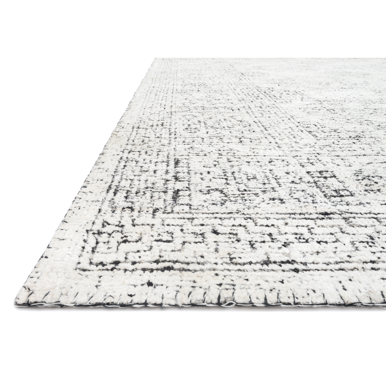 Hand-knotted in India of viscose and cotton, the Vestige White / Black Area Rug recalls ancient khotan rugs in an updated color palette. Soft underfoot, the silken yarns temper the graphic motifs to create a versatile foundation.  Hand Knotted 89% Viscose | 11% Cotton VQ-01 White / Black