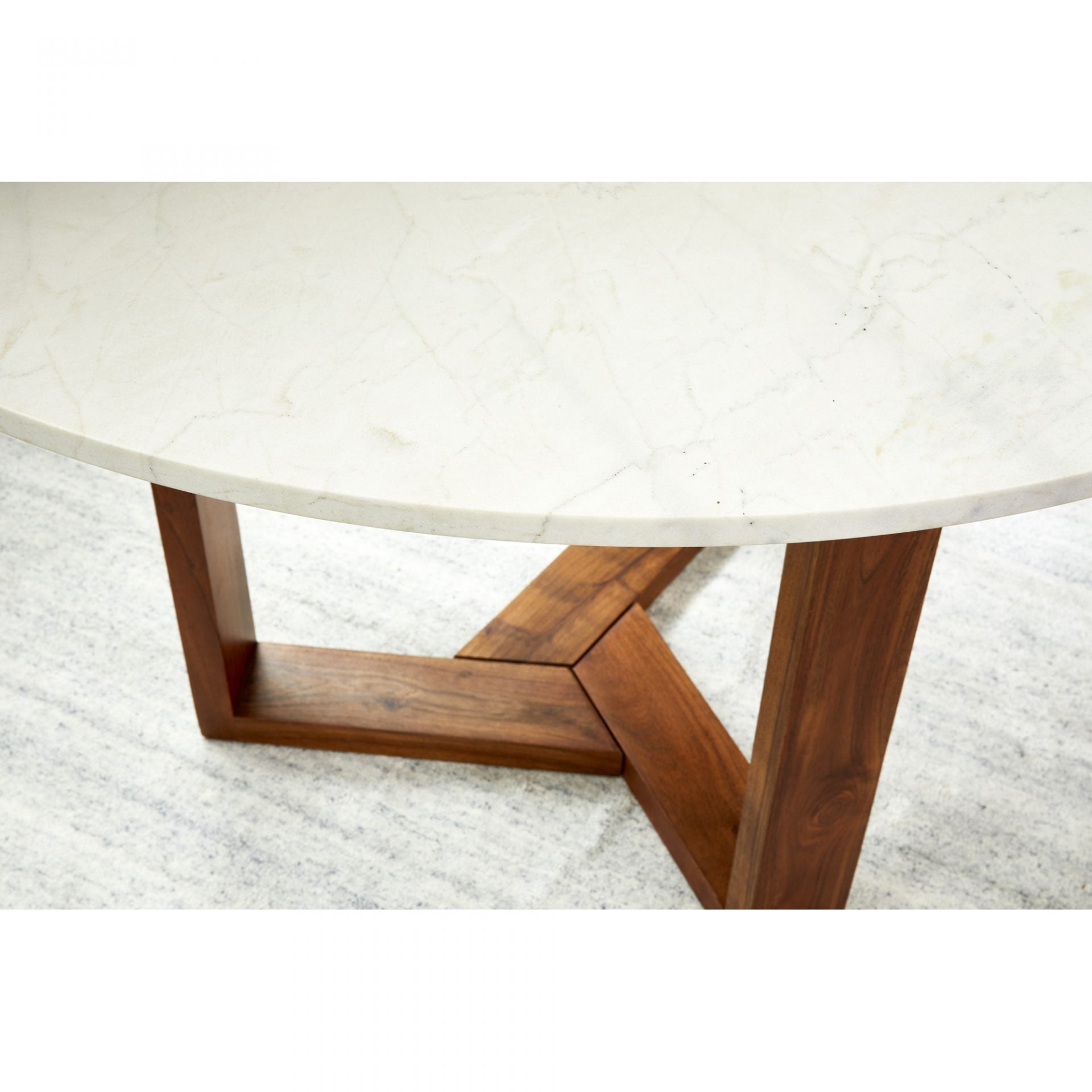 With a solid Satwaria marble tabletop, the Jinxx Dining Table - Brown showcases the best of nature's work. Solid Acacia legs form an ergonomic base that allows 4-6 people to sit comfortably around the table.  Size: 48"W x 48"D x 30"H Materials: White Satwaria Marble Top, Solia Acacia Base, MDF