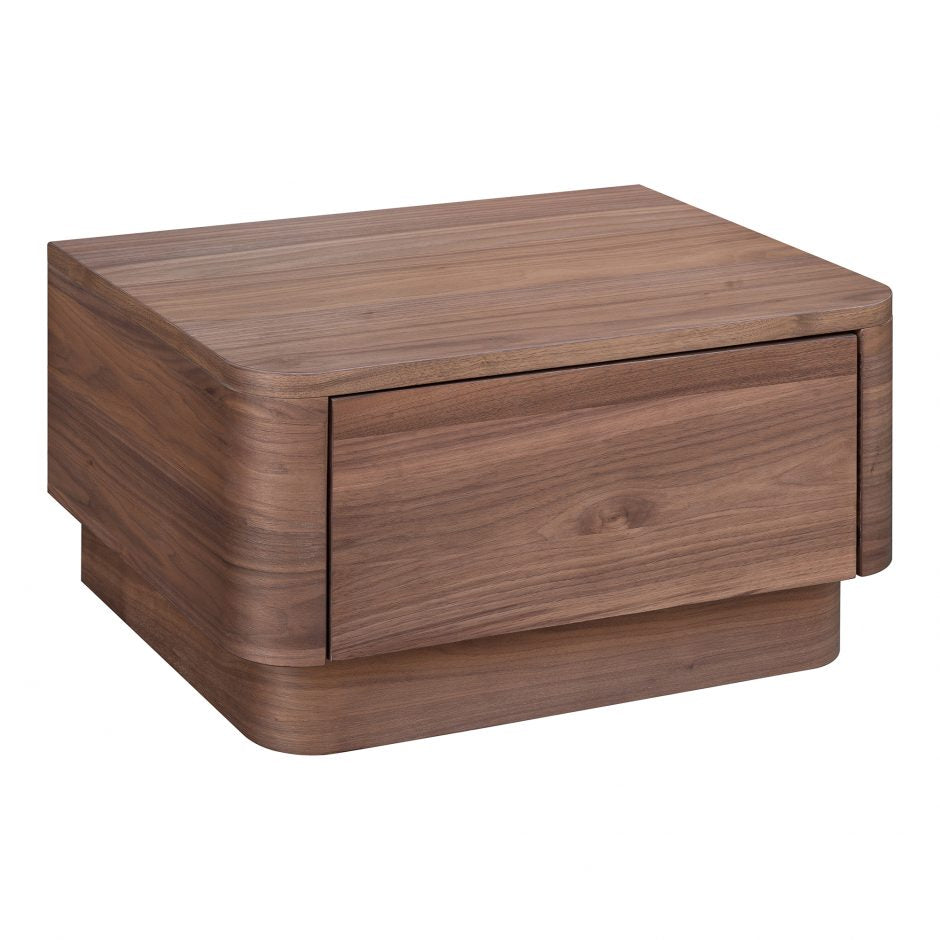 We love the soft, rounded edges of this Round Off Nightstand - Walnut. With a pull out drawer, this is both a functional and beautiful piece to add to any bedroom or guest room!   Size: 20 x 15"D x 11"H Material: Walnut Veneer, MDF, Rubberwood Base