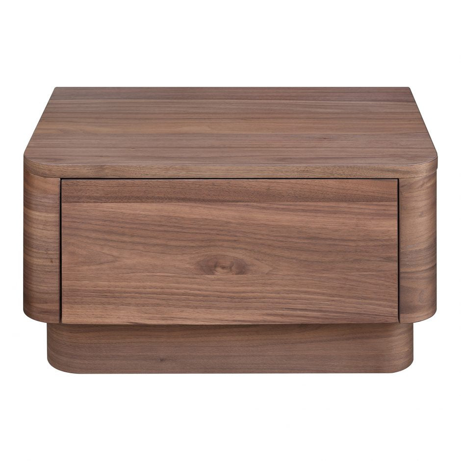 We love the soft, rounded edges of this Round Off Nightstand - Walnut. With a pull out drawer, this is both a functional and beautiful piece to add to any bedroom or guest room!   Size: 20 x 15"D x 11"H Material: Walnut Veneer, MDF, Rubberwood Base