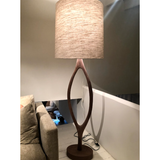 The Urbino Walnut Lamp is crafted from sustainably harvested hardwood by Verellen in North Carolina. The unique shape of the body paired with the oatmeal shade complements any room   Base: 16"w x 8"d x 62"h Overall Height: 76"h