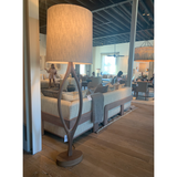 The Urbino Walnut Lamp is crafted from sustainably harvested hardwood by Verellen in North Carolina. The unique shape of the body paired with the oatmeal shade complements any room   Base: 16"w x 8"d x 62"h Overall Height: 76"h